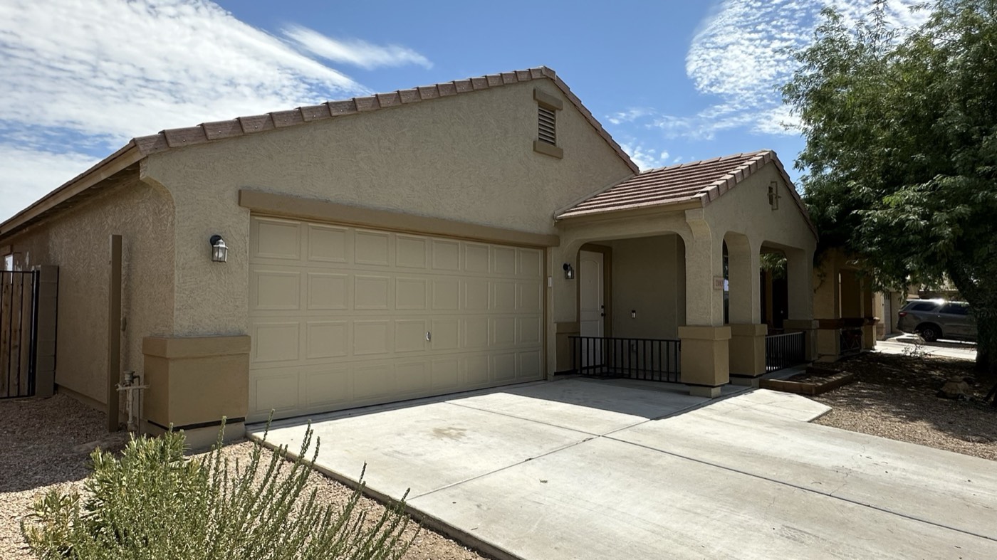 Greige stucco single-storey Phoenix home repainted, shot up the driveway