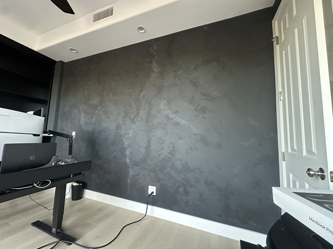 Charcoal limewash accent wall in a home office