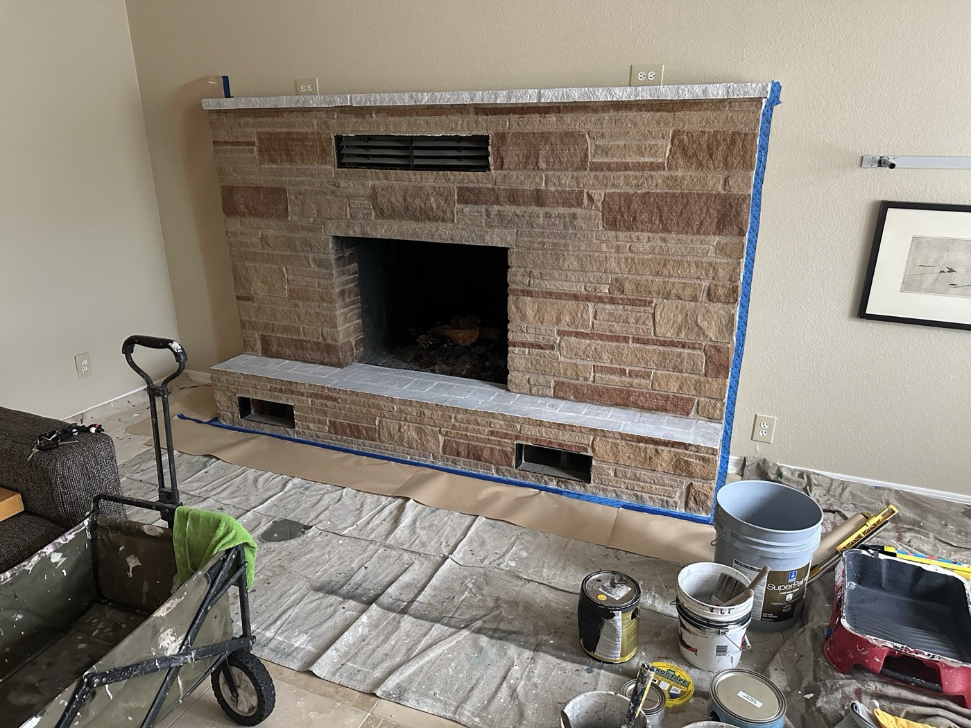 The same ledgestone fireplace before limewash, masked and ready