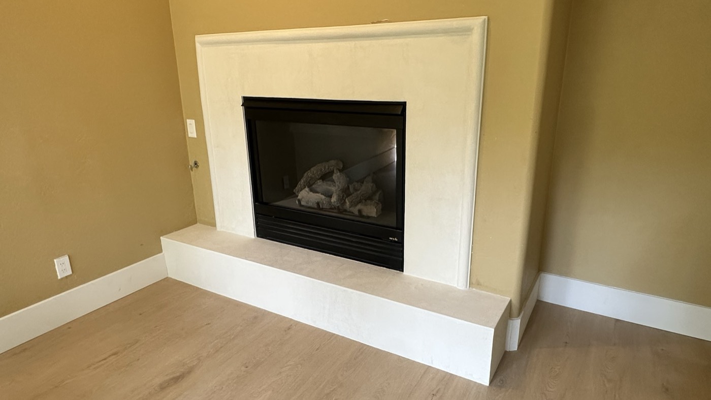 Cream microcement fireplace surround with a floating hearth, Phoenix