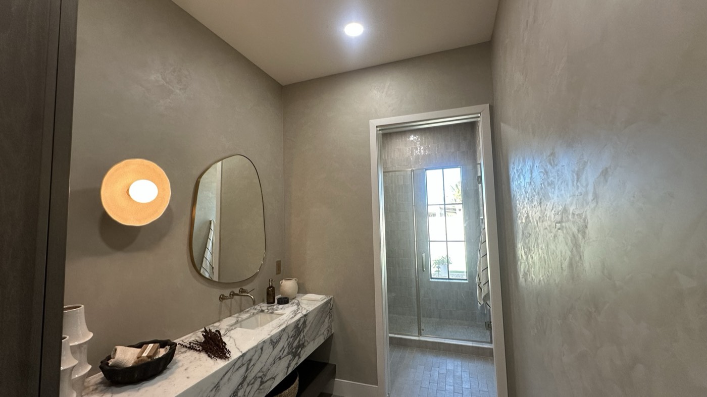 Moroccan clay tadelakt powder bath with a marble vanity in Phoenix