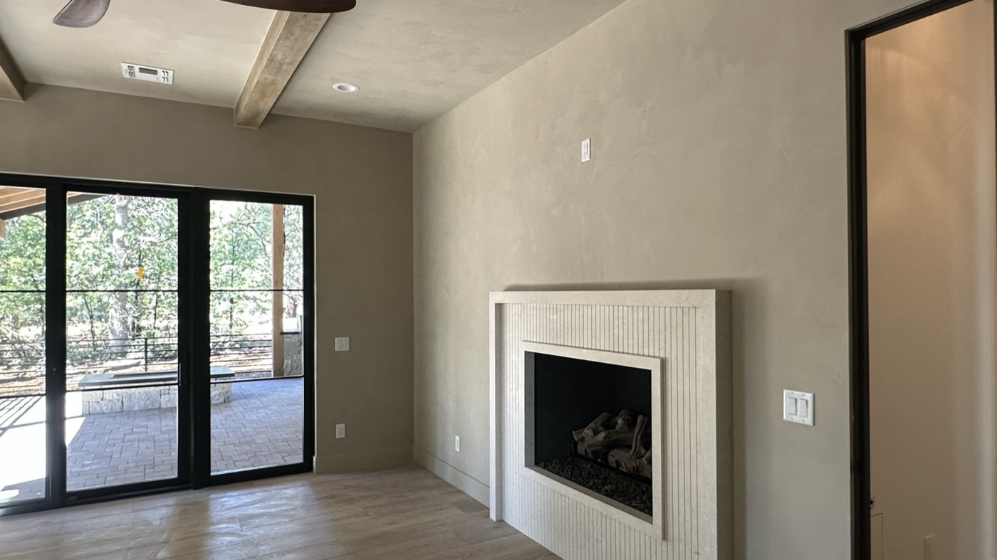 Roman clay hearth wall with a fluted plaster fireplace surround