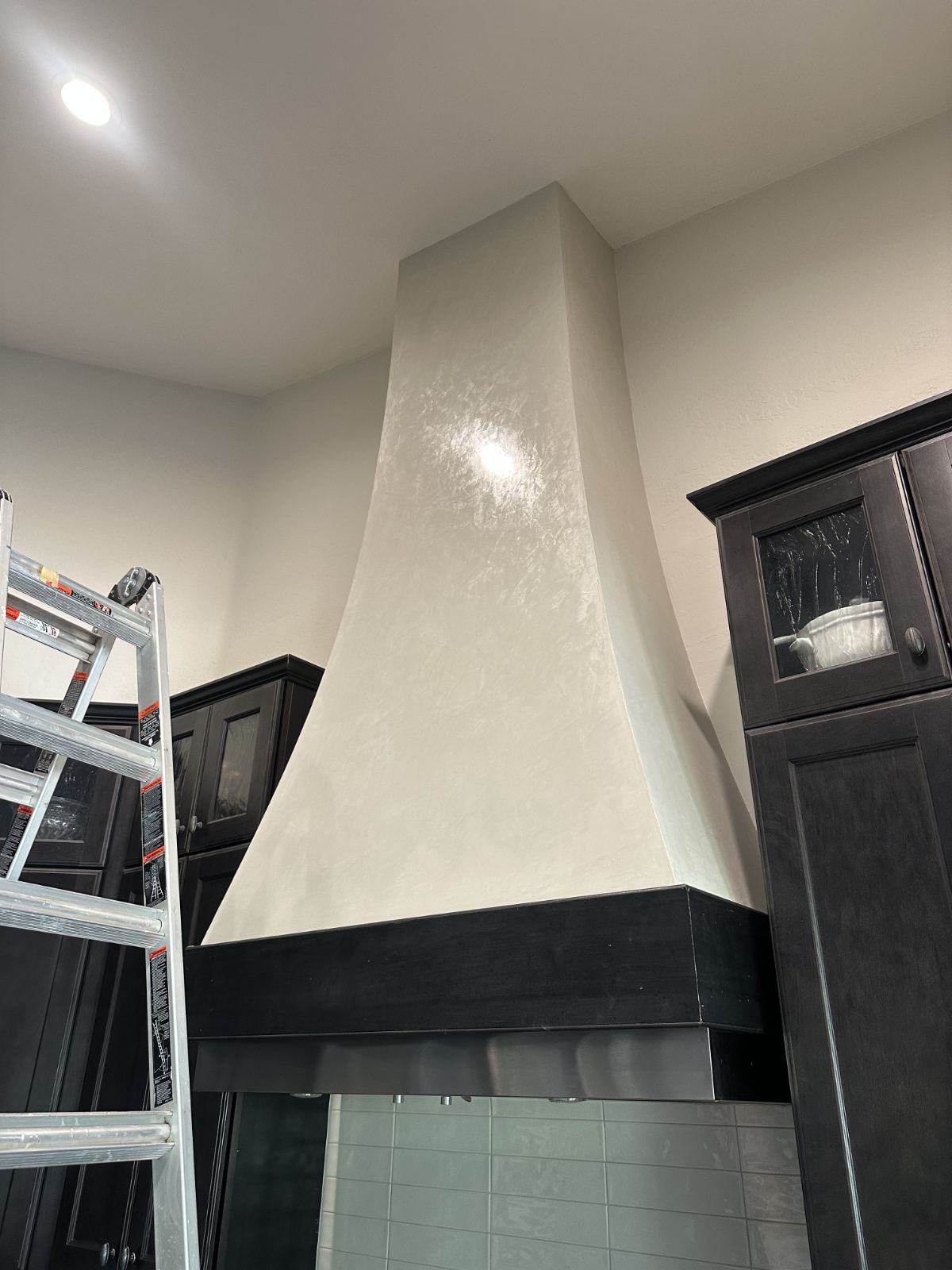 Artisan burnishing a Venetian plaster feature wall in Phoenix